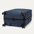 Bottom view of Travelpro Maxlite Air V2 Check-In Spinner in Midnight Blue, showing dual spinner wheels and side carry handle.

