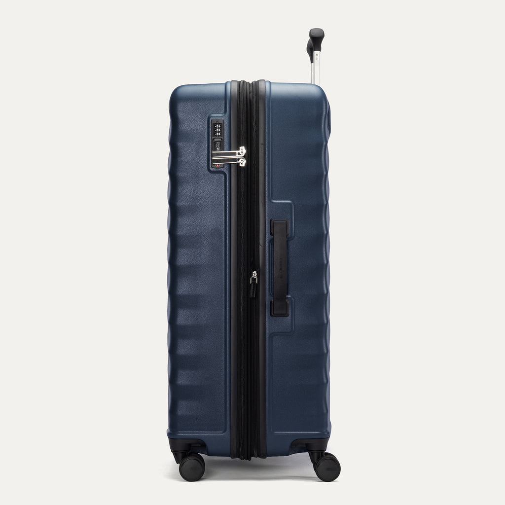 Side view of Travelpro Maxlite Air V2 Check-In Spinner in Midnight Blue, showing expandable zipper, Low-Profile Side Carry Handle, and extended PowerScope Lite Handle
