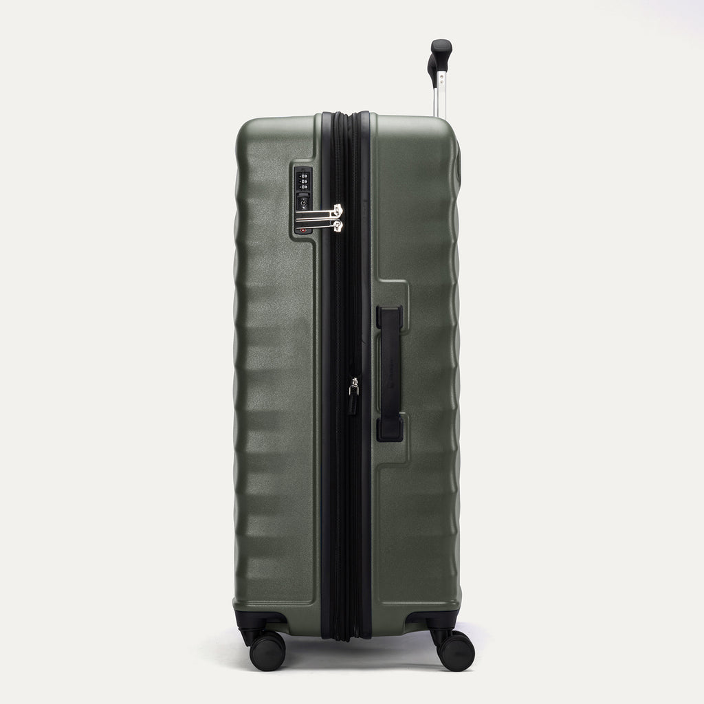 Side view of Travelpro Maxlite Air V2 Check-In Spinner in Slate Green, showing expandable zipper, Low-Profile Side Carry Handle, and extended PowerScope Lite Handle.