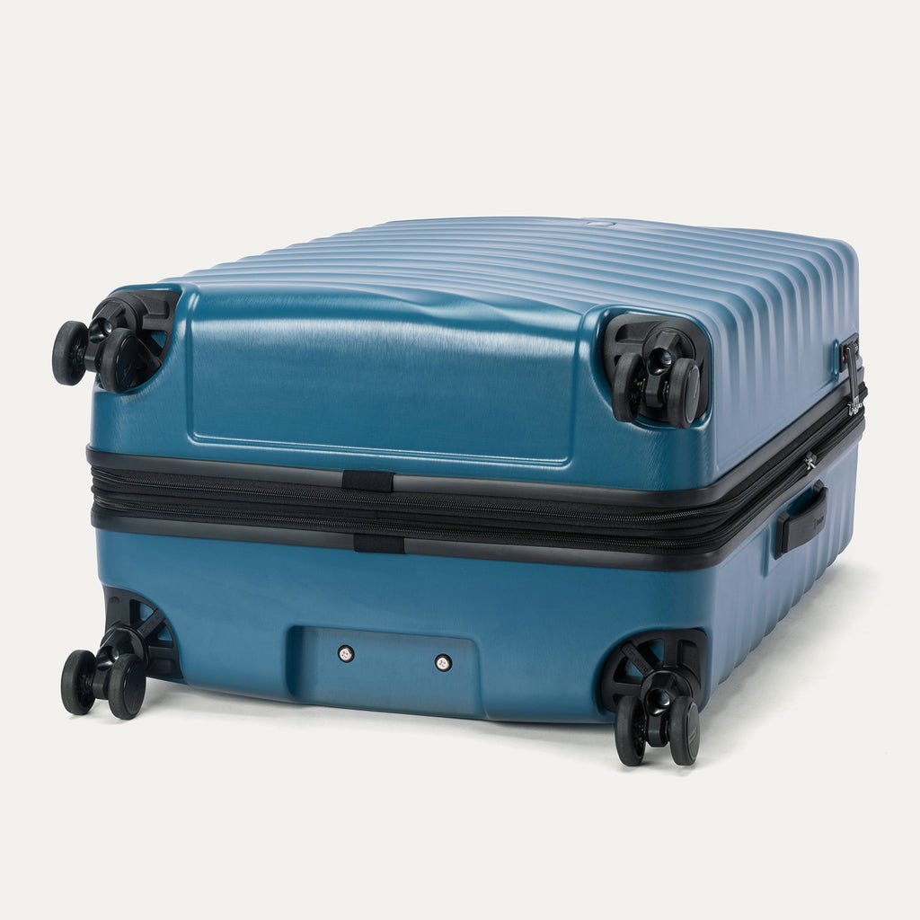 Bottom view of Travelpro Maxlite Air V2 Check-In Spinner in Teal, showing dual spinner wheels and side carry handle.