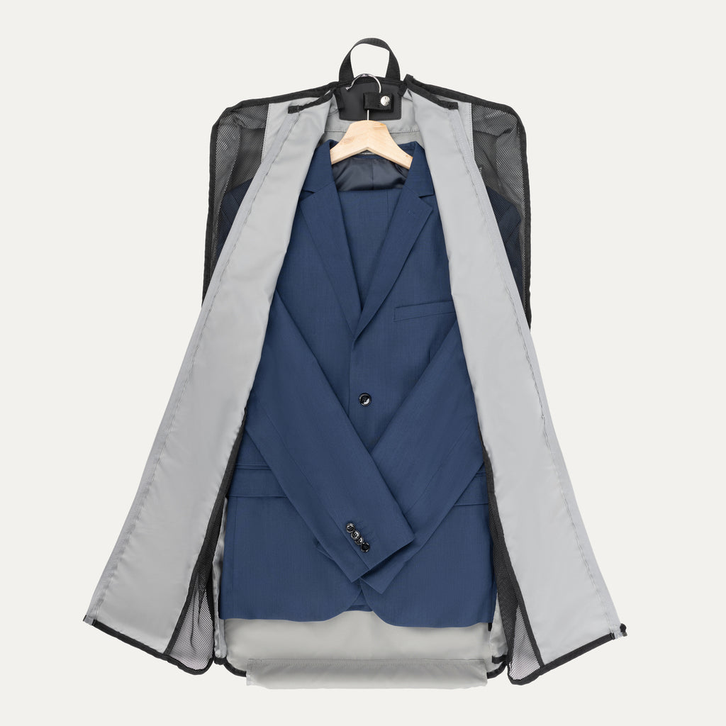 Travelpro® Essentials™ Drop-in Garment Sleeve opened to reveal a neatly packed  suit