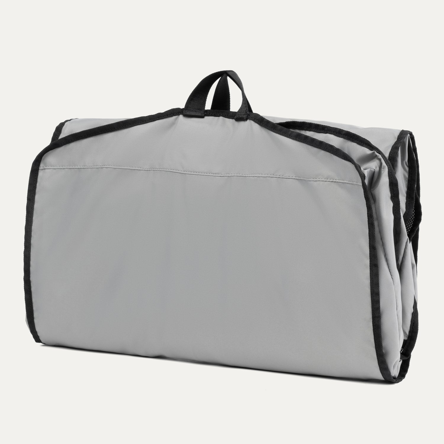 Travelpro® Essentials™ Drop-in Garment Sleeve shown folded upright with black trim edges and a top carrying handle, highlighting its compact and portable design.