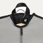 Close-up view of the Travelpro® Essentials™ Drop-in Garment Sleeve, showing the top section with a garment hanger secured by a reinforced snap-tab closure and a durable zipper