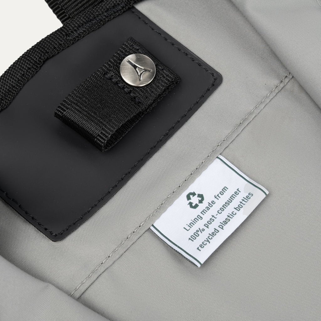 Close-up of the Travelpro® Essentials™ bag interior tag, showing the eco-friendly lining made from 100% post-consumer recycled plastic bottles