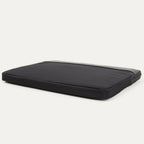 Travelpro® Essentials™ 13"/14" Laptop Sleeve in Black, shown lying flat at an angle to display its slim, padded design
