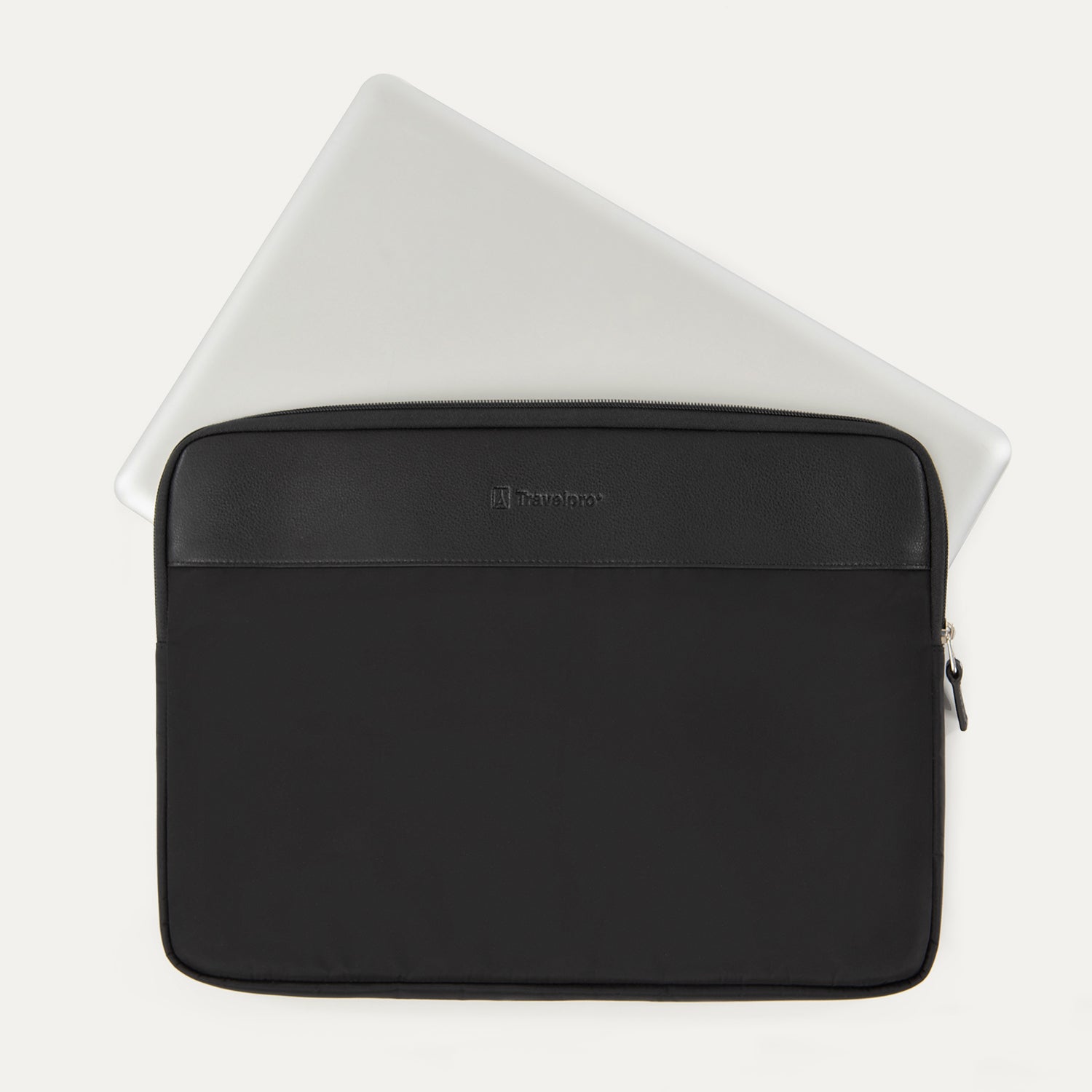Travelpro® Essentials™ 13"/14" Laptop Sleeve in Black, shown with a laptop partially inserted to highlight its slim, protective fit, featuring a leather-accented top panel and secure side zipper closure.
