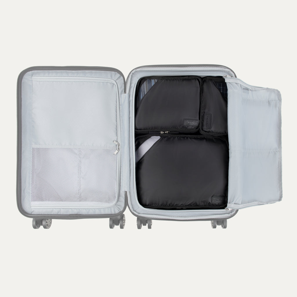 Top view of Travelpro Essentials 3 Pack Packing Cube Set in BLACK, efficiently arranged inside an open hardside carry-on.