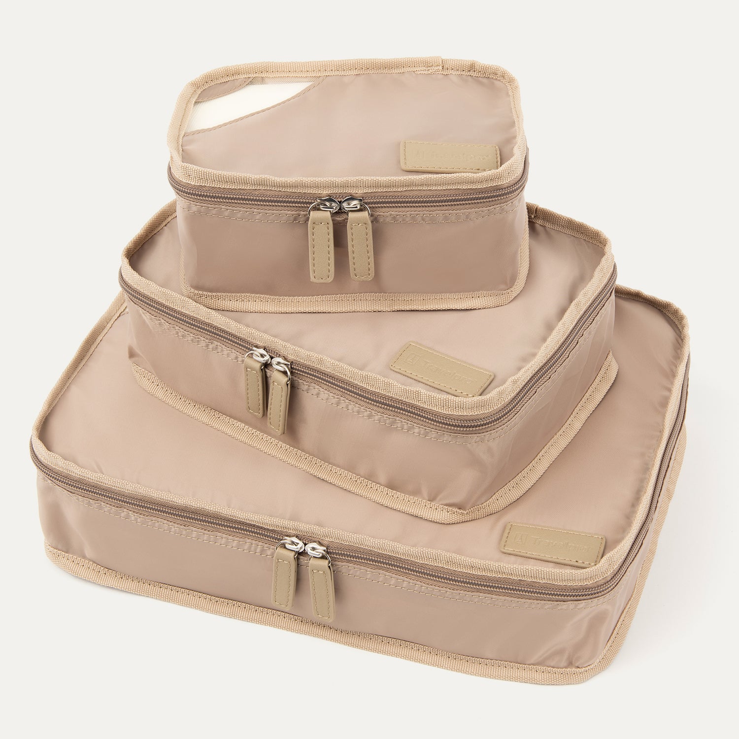 Angled front view of Travelpro Essentials 3 Pack Packing Cube Set (S/M/L) in KHAKI, stacked to show dual-zip closures and accent panels.
