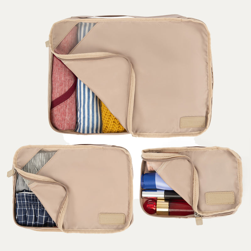 Top view of Travelpro Essentials 3 Pack Packing Cube Set (S/M/L) in KHAKI, partially open to reveal organized contents.
