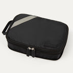 A black Travelpro Essentials medium expandable/compressible packing cube with a silver zipper.