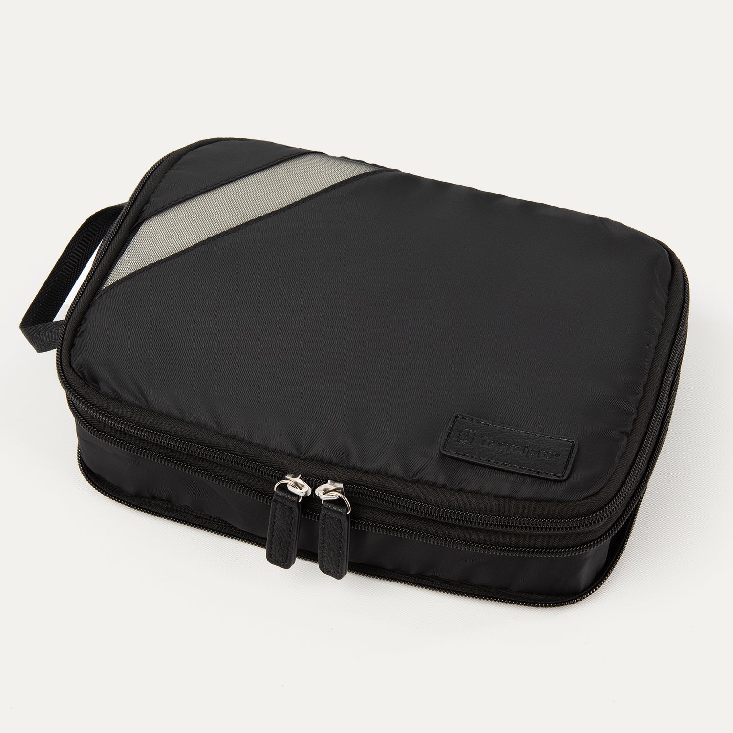 A black Travelpro Essentials medium expandable/compressible packing cube with a silver zipper.