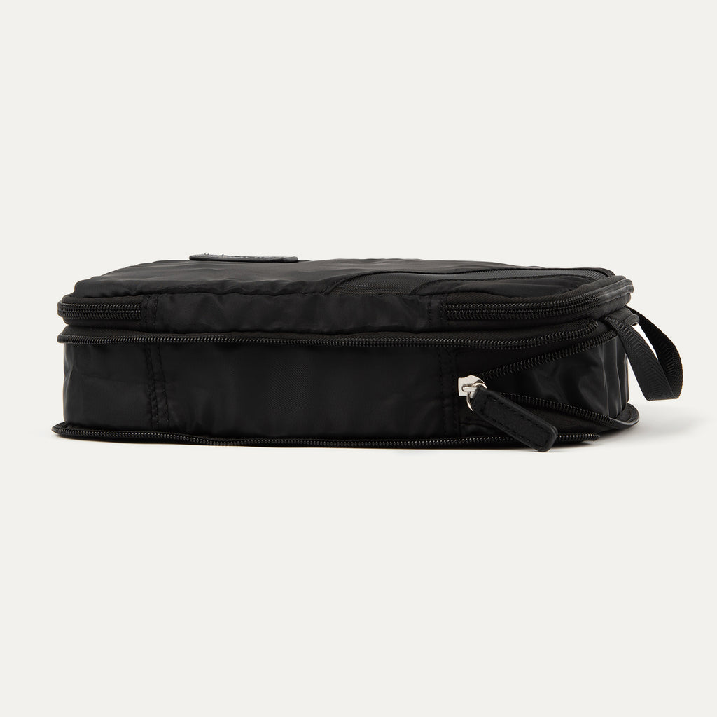 Rear expanded view of the Travelpro® Medium Packing Cube in black with a side handle and dual zipper closures.
