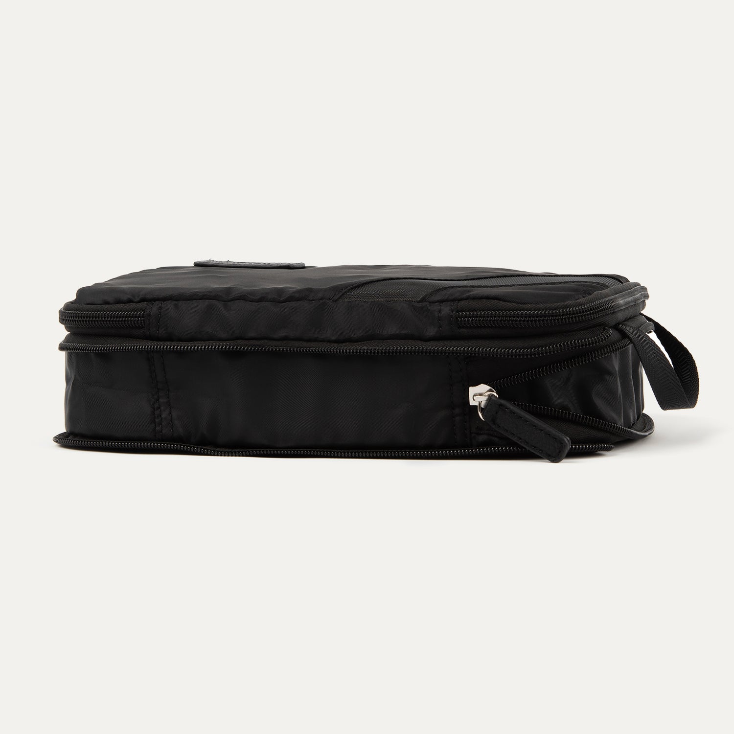 Rear expanded view of the Travelpro® Medium Packing Cube in black with a side handle and dual zipper closures.

