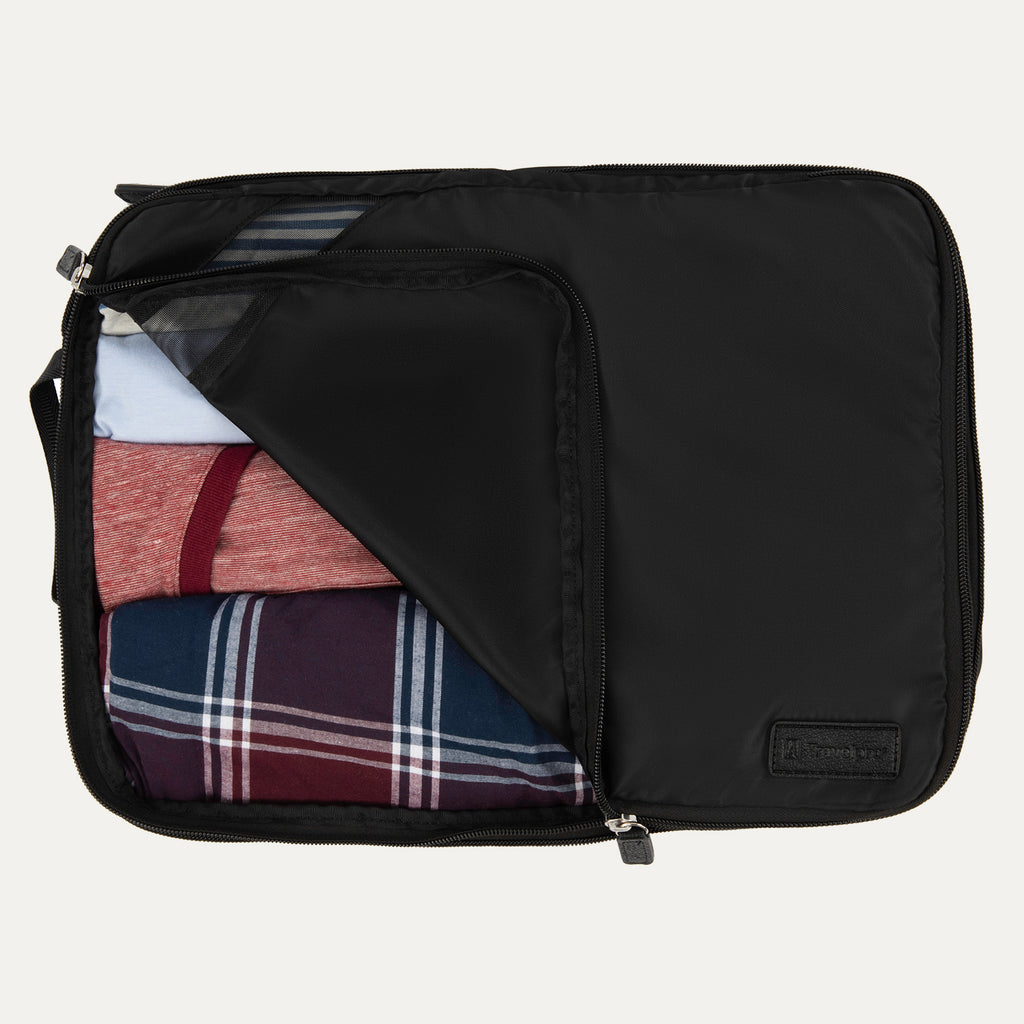 Large Travelpro packing cube in black with mesh panel, partially unzipped to reveal rolled clothing inside.
