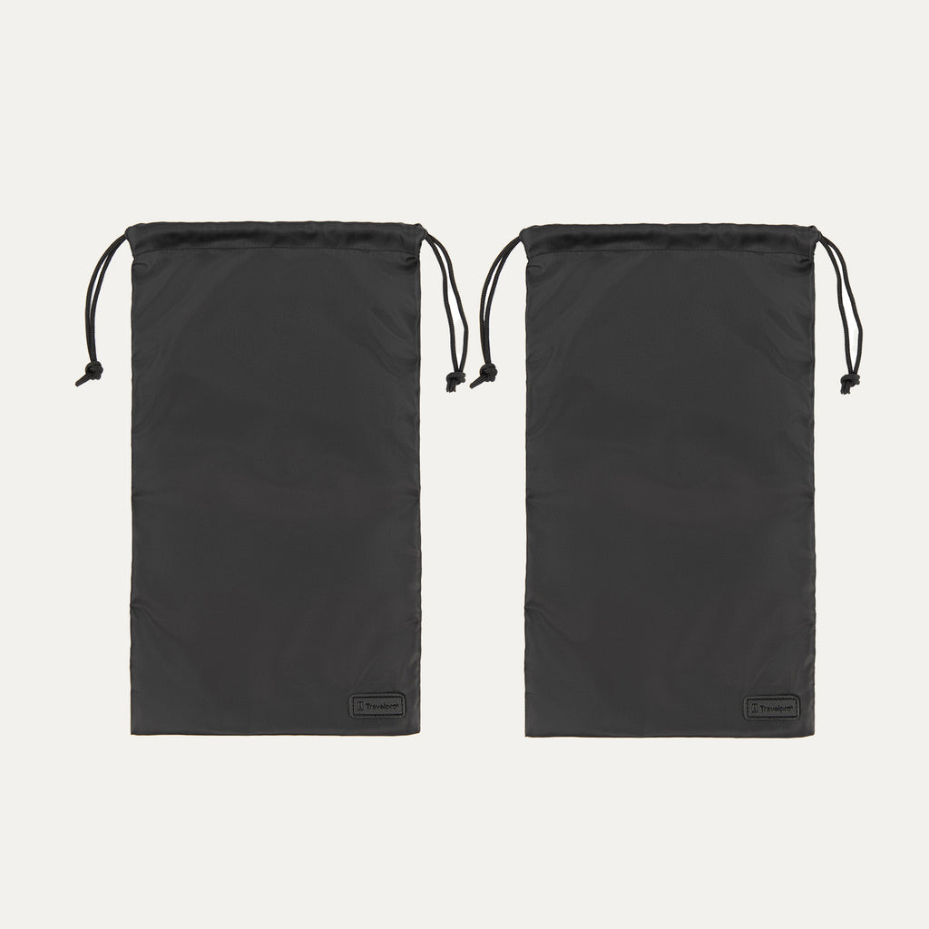 Two black Travelpro drawstring shoe bags made from lightweight fabric, each featuring a pull cord closure at the top and a small Travelpro logo tag at the bottom corner.