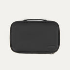 Travelpro Split Case Toiletry Bag in black with a top carry handle and Travelpro logo patch.
