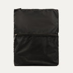 A black Travelpro Essentials washable travel laundry bag with a mesh pocket on the front