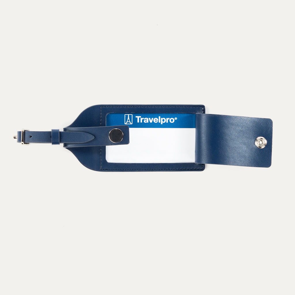 Open view of Travelpro Essentials Leather Luggage Tag in Navy, revealing ID window and snap-closure privacy flap.