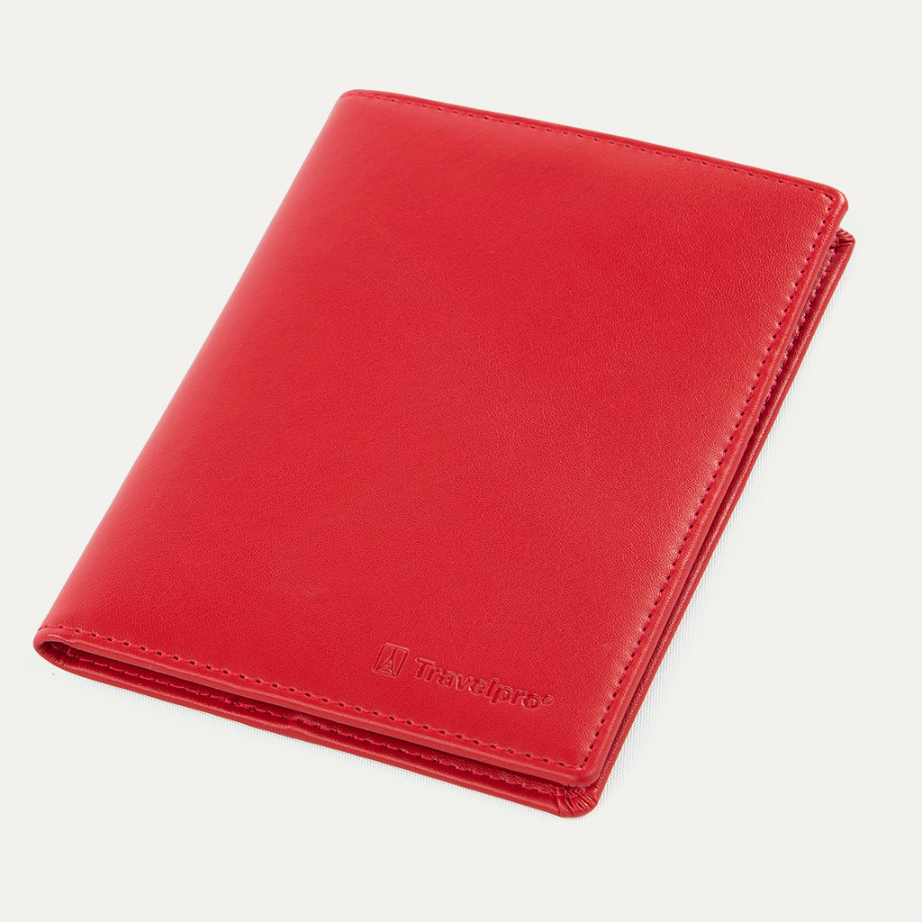 Closed red Travelpro® leather passport cover with a smooth finish and stitched edges, embossed with the Travelpro® logo on the front.