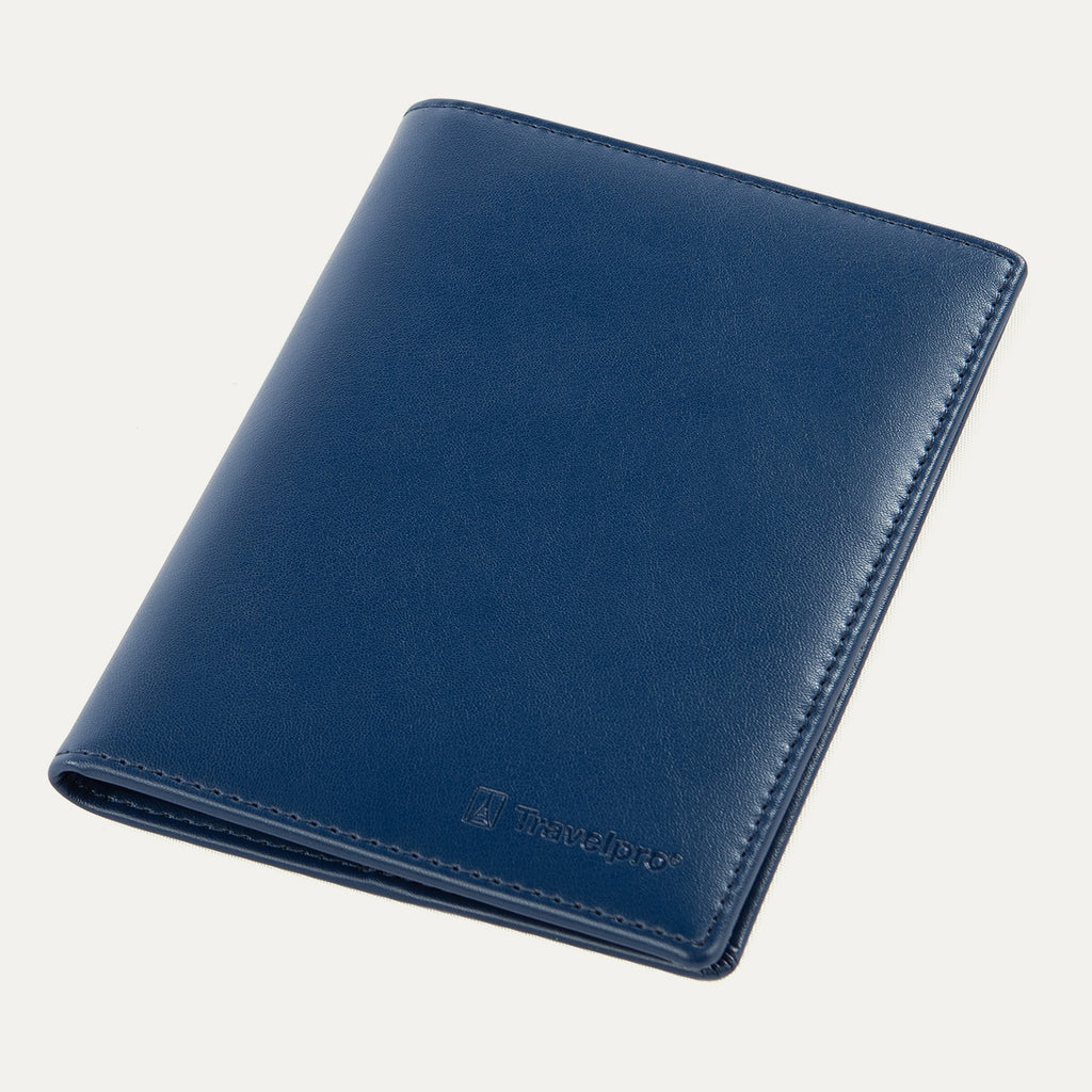 Travelpro® Passport Cover in navy, crafted from smooth leather with fine stitching along the edges and an embossed Travelpro® logo at the bottom corner