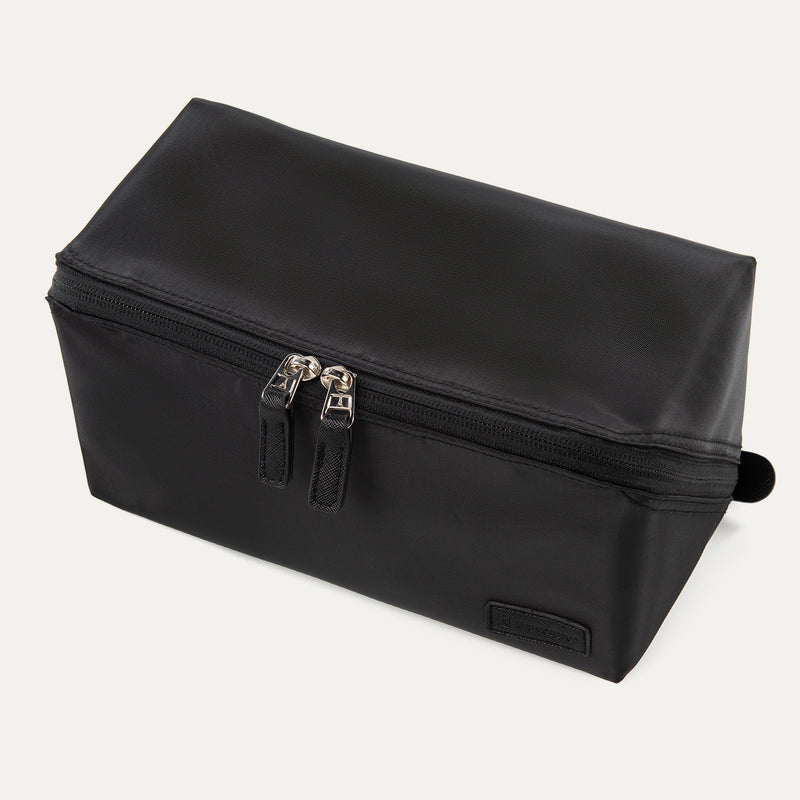 Front angled view of the Travelpro® MaxAccess Cubes™ Toiletry Organizer in black with dual zippers and a structured rectangular design.
