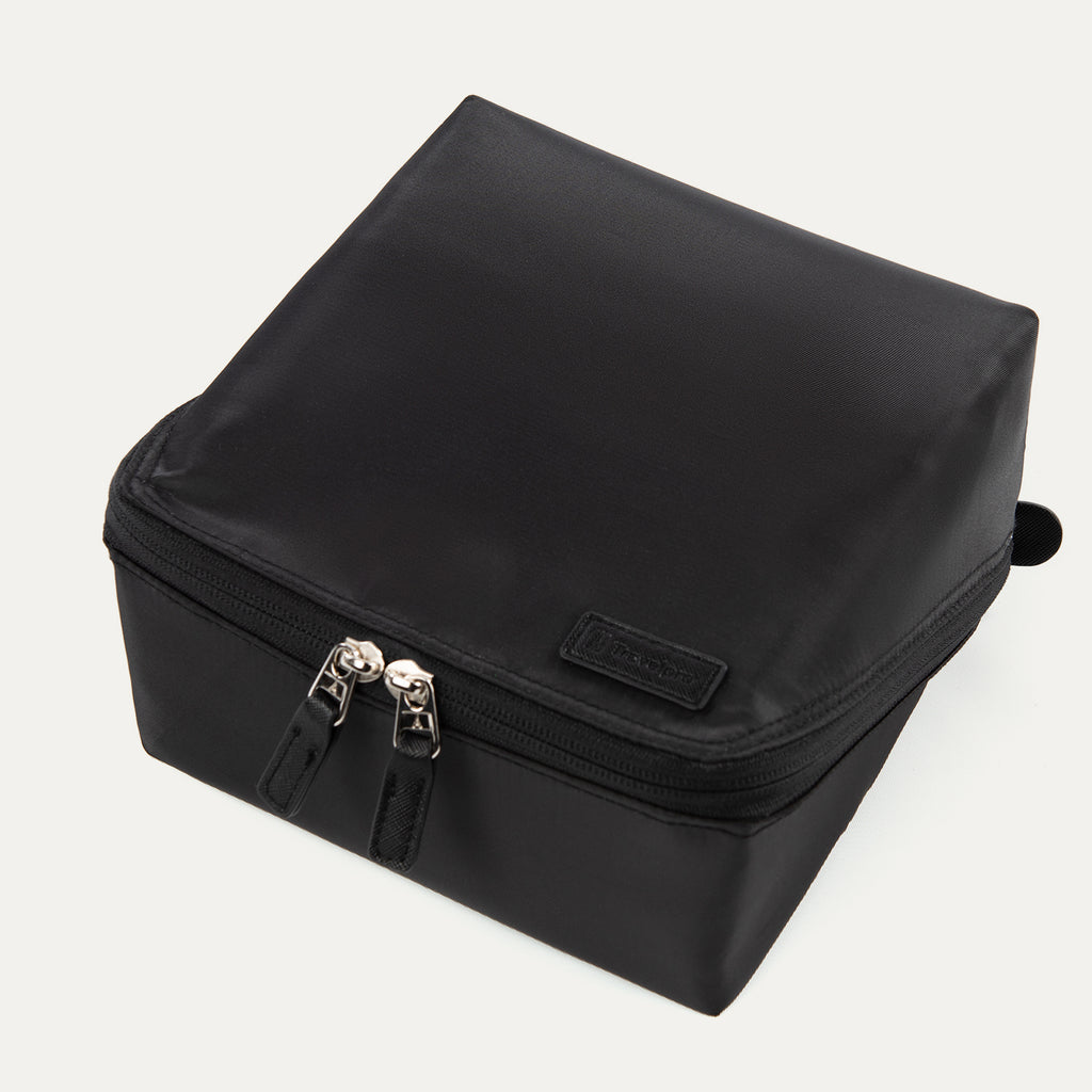 Top view of the MaxAccess Cubes™ Deluxe Hanging Toiletry Organizer in black, showing its dual zippers and a Travelpro logo patch on the front