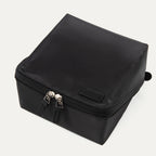 Top view of the MaxAccess Cubes™ Deluxe Hanging Toiletry Organizer in black, showing its dual zippers and a Travelpro logo patch on the front