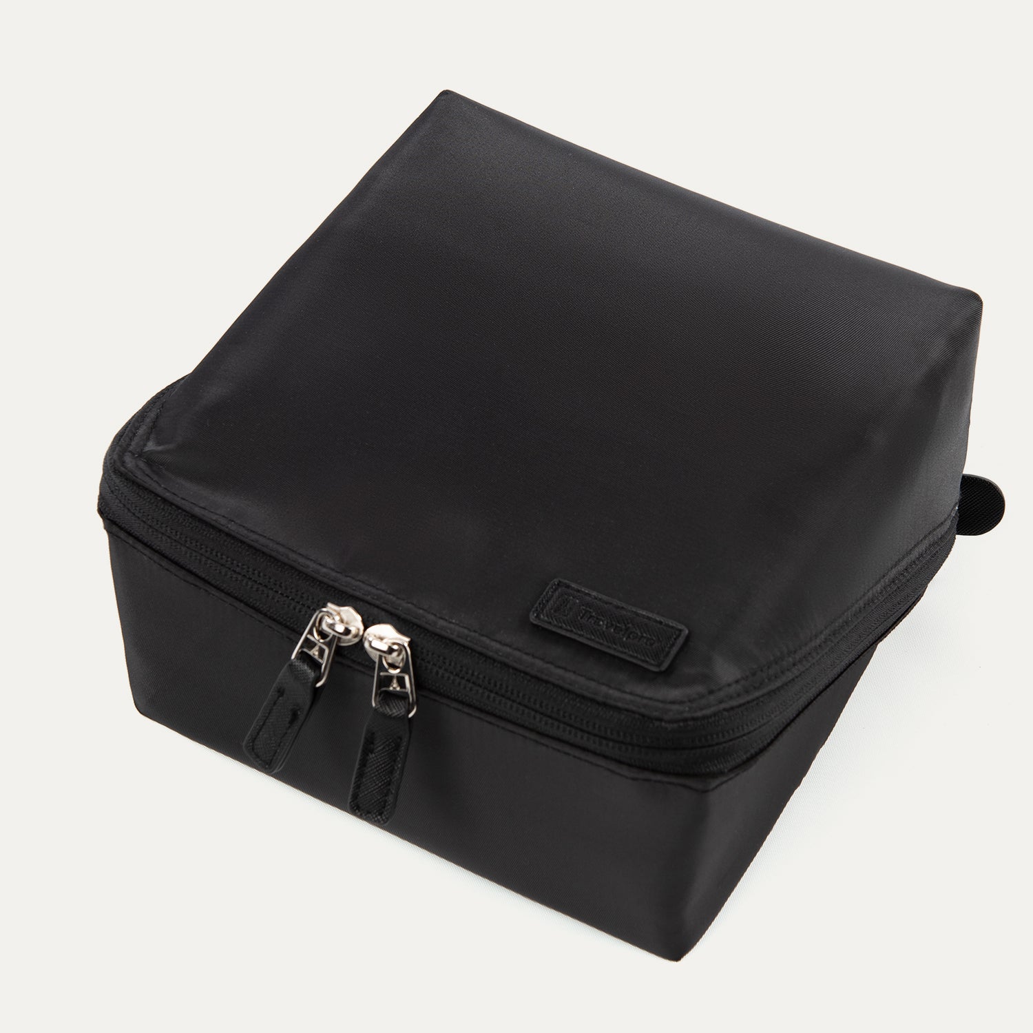 Top view of the MaxAccess Cubes™ Deluxe Hanging Toiletry Organizer in black, showing its dual zippers and a Travelpro logo patch on the front