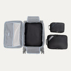 Top view of Travelpro Essentials 3 Pack Expandable/Compressible Packing Cube Set (Medium, Large, Extra Large) in BLACK, with Extra Large packed in suitcase and Medium and Large placed outside.