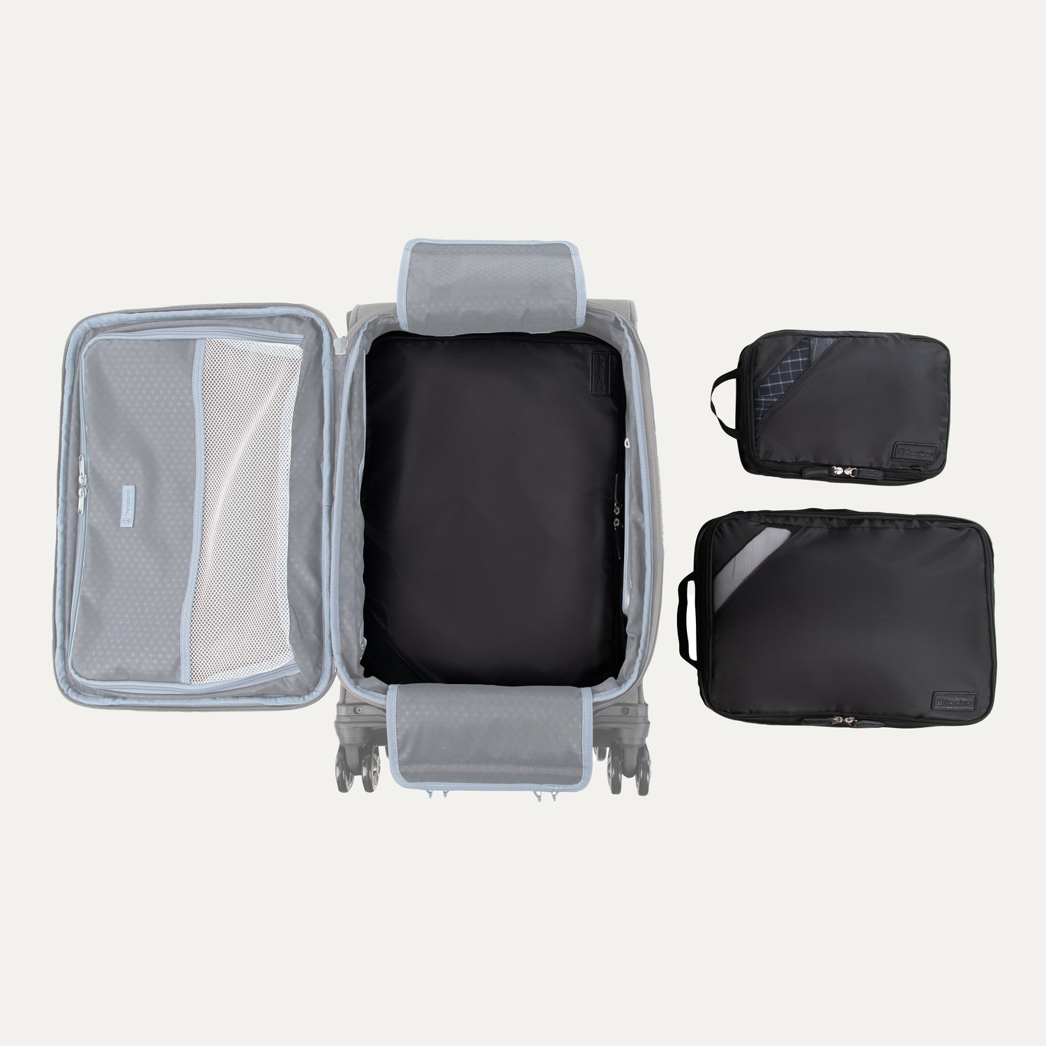 Top view of Travelpro Essentials 3 Pack Expandable/Compressible Packing Cube Set (Medium, Large, Extra Large) in BLACK, with Extra Large packed in suitcase and Medium and Large placed outside.