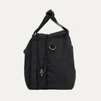 Side view of Expanded Travelpro Essentials 2-in-1 Travel Tote & Cooler in Black, showing dual top handles and D-ring for strap attachment.
