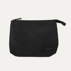 Folded view of the Travelpro Essentials SparePack Foldable Tote 2.0 in Black, showing the bag packed down into its own compact, zippered storage pouch for easy transport when not in use.