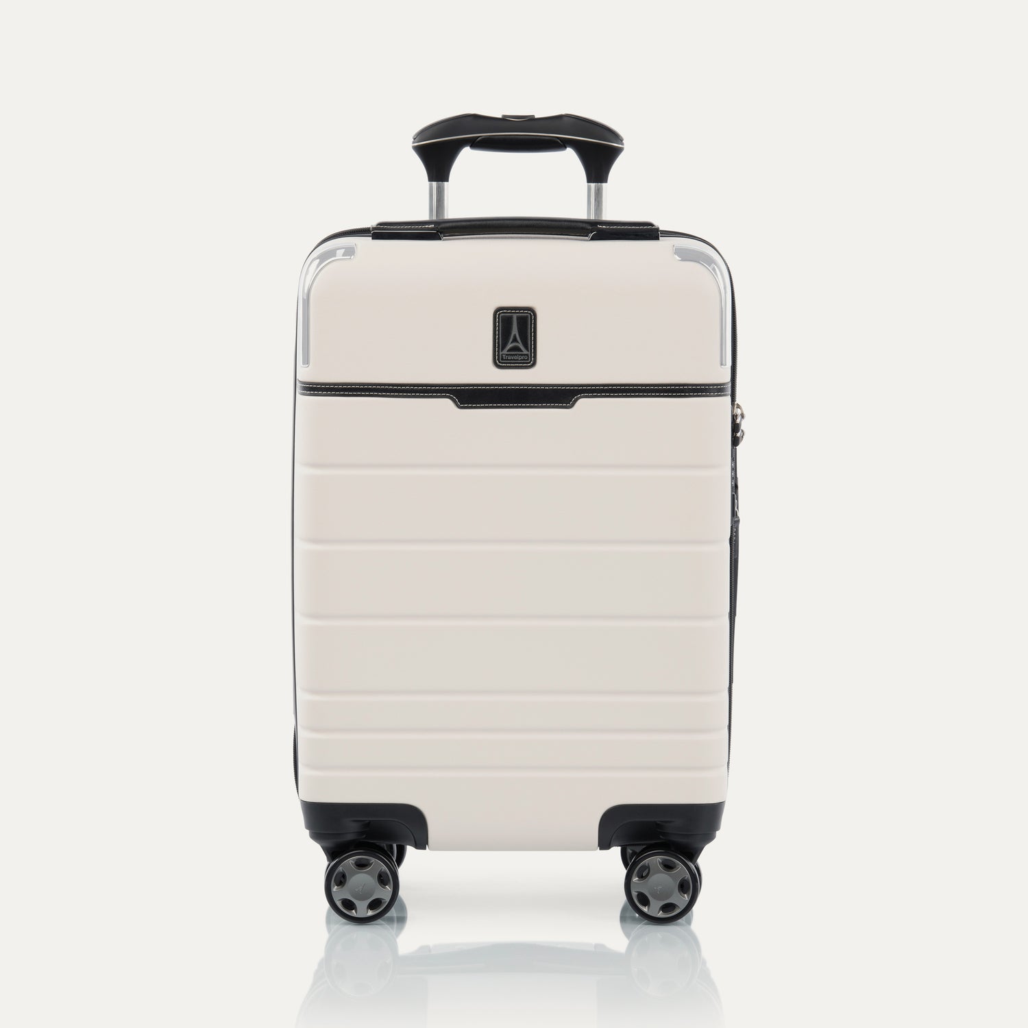 Front view of T+L Compact Carry-On Spinner in White Sand, shown with grooved shell and four 360° Spinner Wheels.
