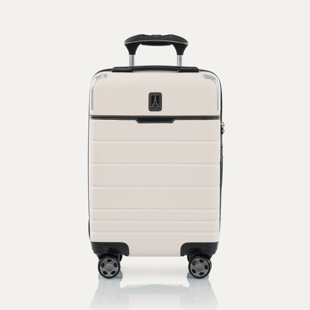 Front view of T+L Compact Carry-On Spinner in White Sand, shown with grooved shell and four 360° Spinner Wheels.
