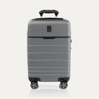 Front view of T+L Carry-On Spinner in Whistler Grey, featuring a matte hard shell, tonal trim, horizontal grooves, and dual spinner wheels.
