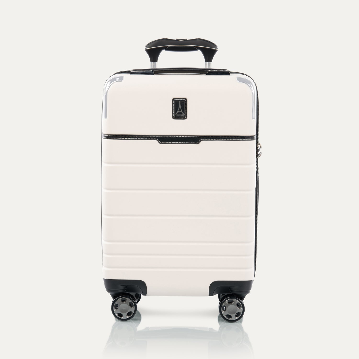 Front view of T+L Carry-On Spinner in White Sand, showing a hard shell with black trim, horizontal grooves, and dual spinner wheels.

