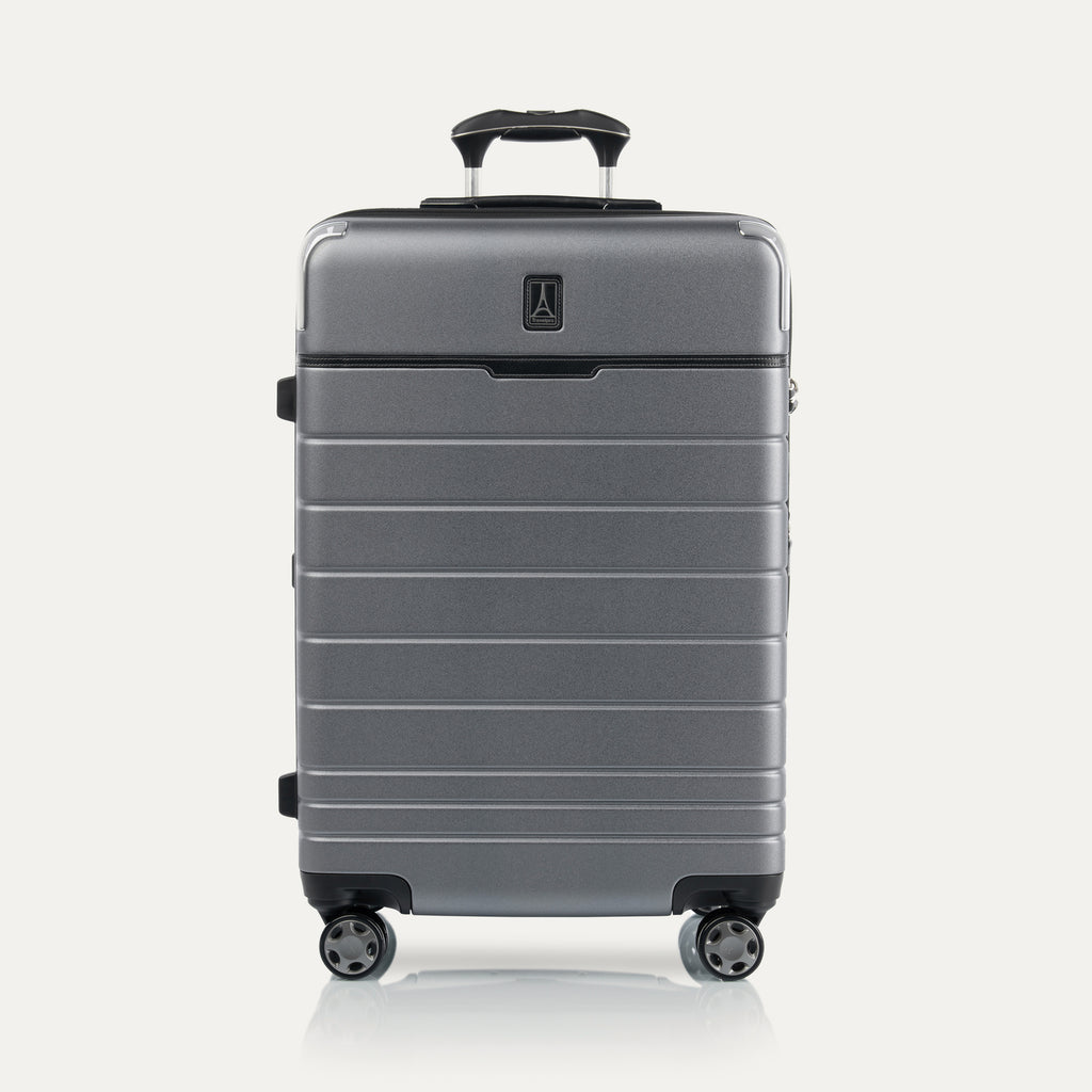 Front view of Travel + Leisure® Medium Check-In Expandable Spinner in Whistler Grey, with textured hard shell, black trim, and dual spinner wheels.
