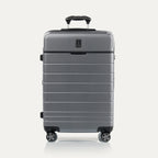 Front view of Travel + Leisure® Medium Check-In Expandable Spinner in Whistler Grey, with textured hard shell, black trim, and dual spinner wheels.

