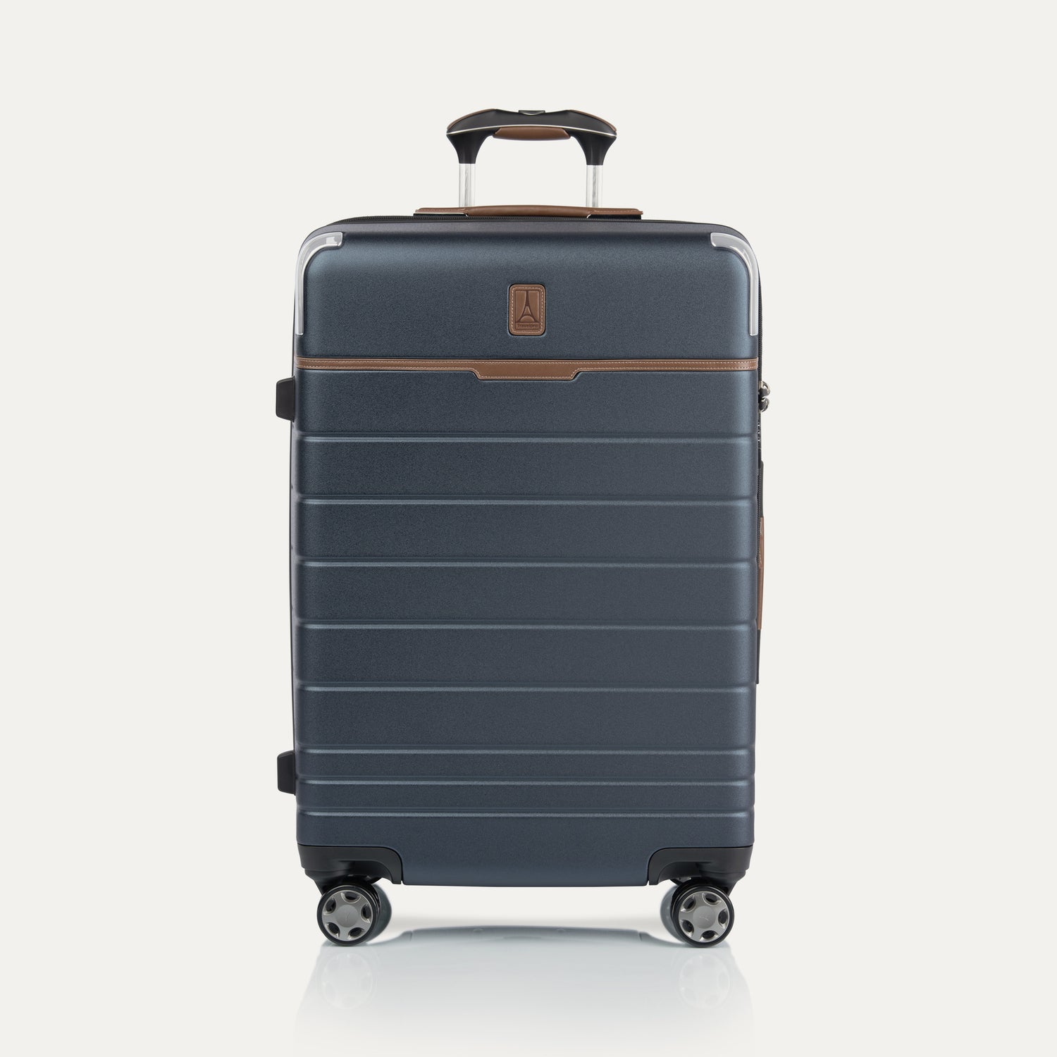 Front view of  Medium Check-In Spinner in Monaco Blue, featuring brown trim, hard shell exterior, and dual spinner wheels.
