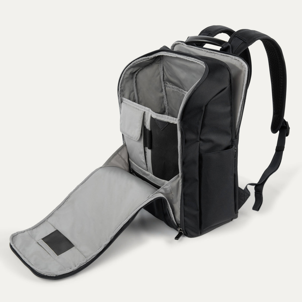 Open interior view of the Crew Executive Choice 3 Slim Laptop Backpack, highlighting the padded laptop and tablet sleeves alongside multiple interior organizational pockets for efficient packing.
