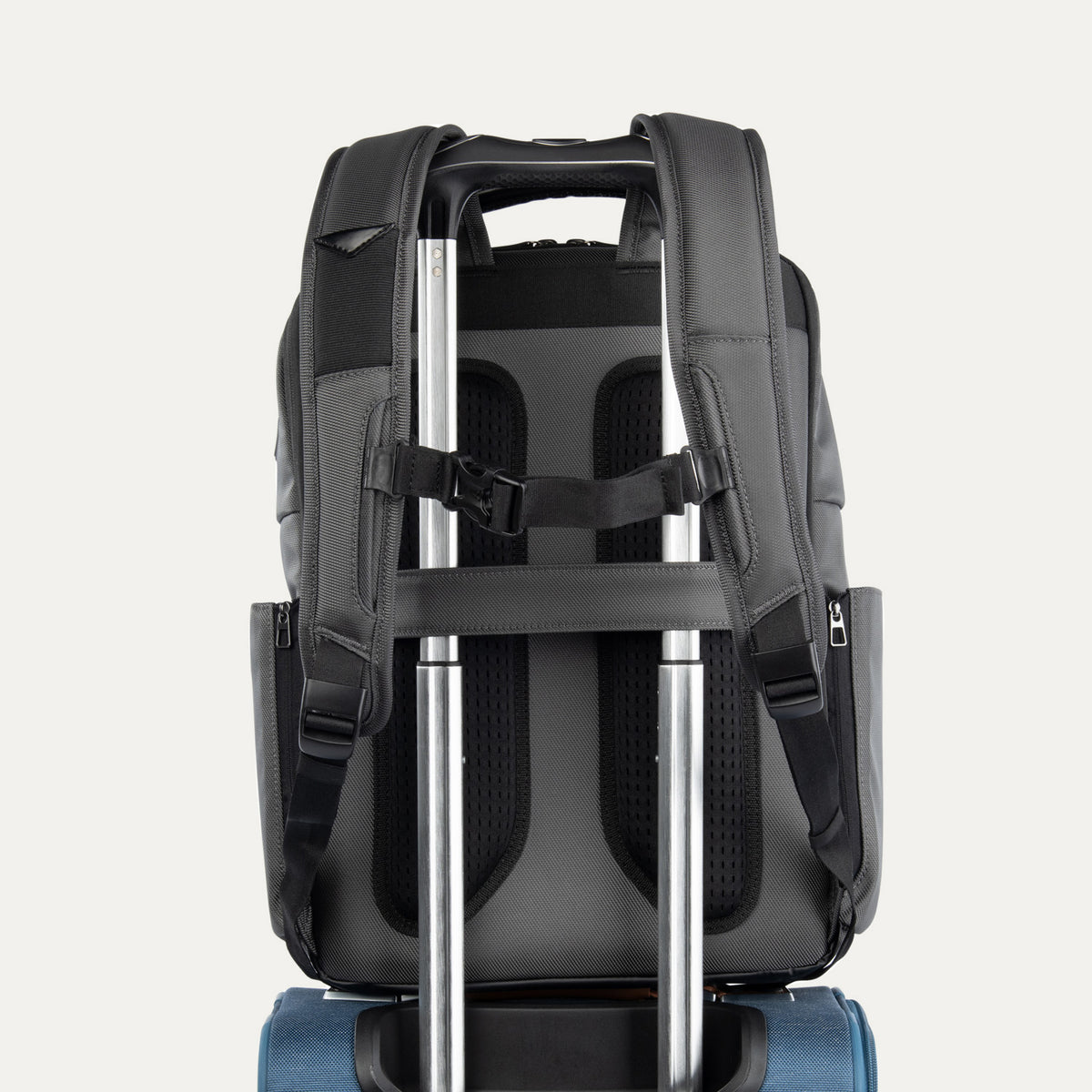 Rear view of the Crew Executive Choice 3 Large Travel Backpack in Titanium Grey, showcasing the ergonomic airflow back panel, adjustable shoulder straps, and the integrated rear stacking strap designed for secure, hands-free mobility on roller luggage.