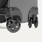 Close-up of the Travelpro Crew Classic Spinner in Titanium Grey, highlighting the 360° Spinner Wheels.
