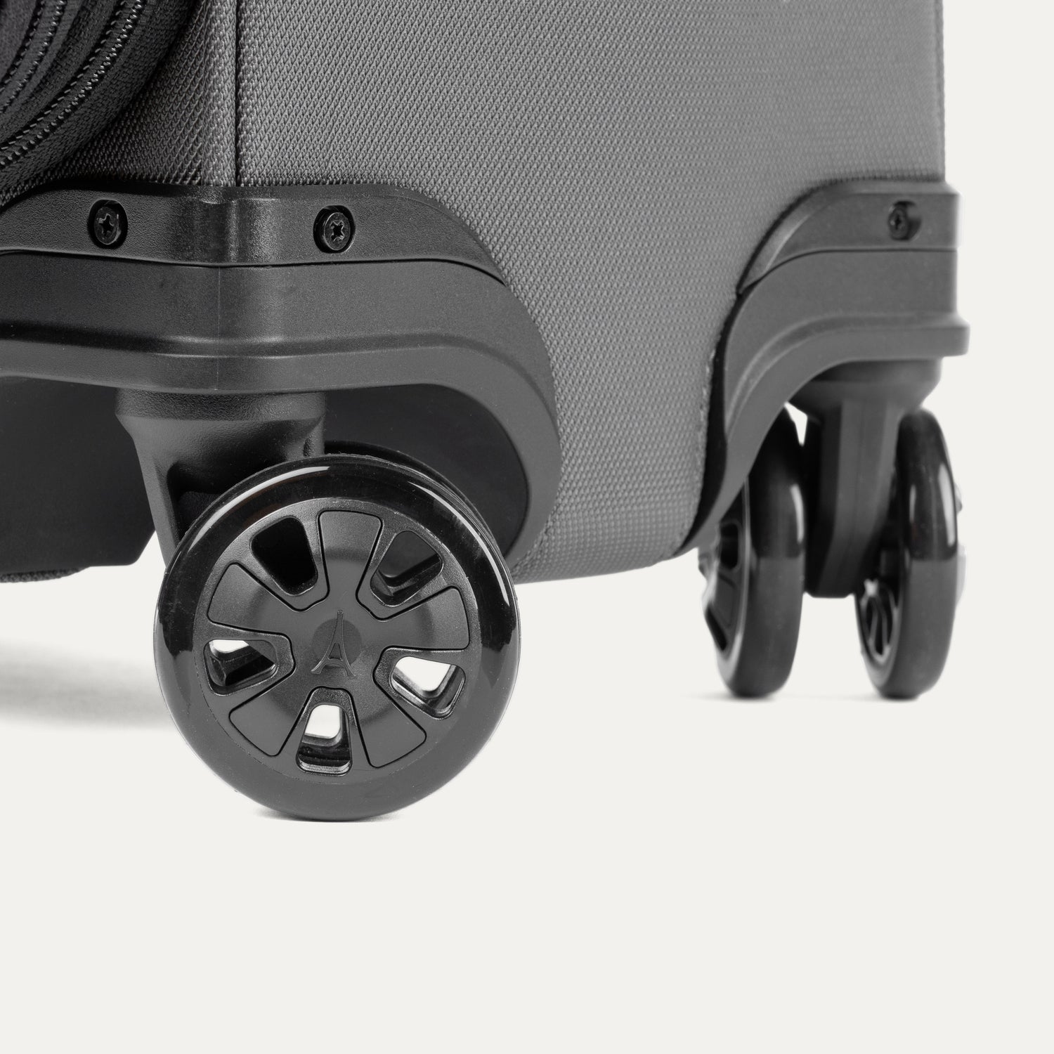 Close-up of the Travelpro Crew Classic Spinner in Titanium Grey, highlighting the 360° Spinner Wheels.
