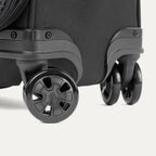 Close-up of the Travelpro Crew Classic Carry-On Spinner in Black, highlighting the 360° Spinner Wheels.
