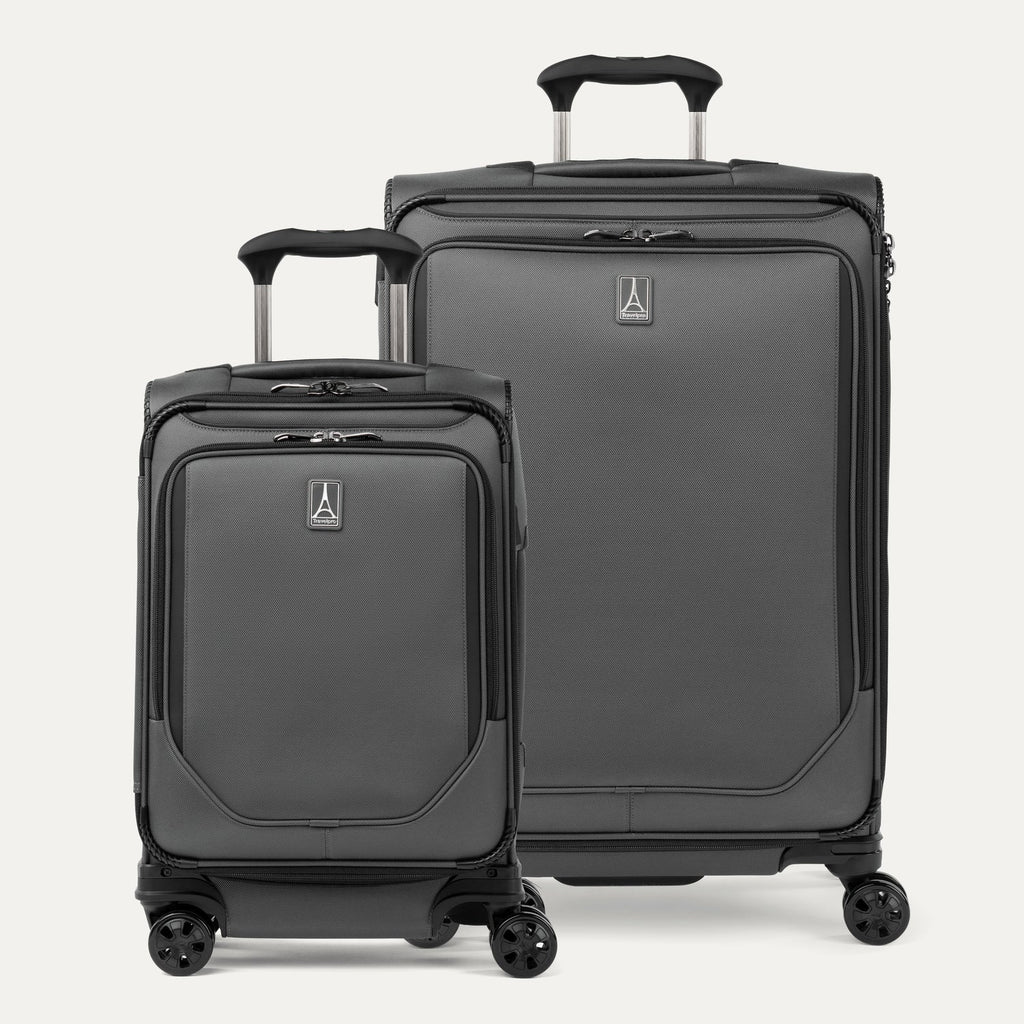 A set of two gray spinner suitcases, one carry-on size and one check-in size on a white background 