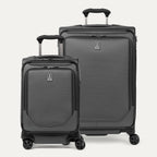 A set of two gray spinner suitcases, one carry-on size and one check-in size on a white background 