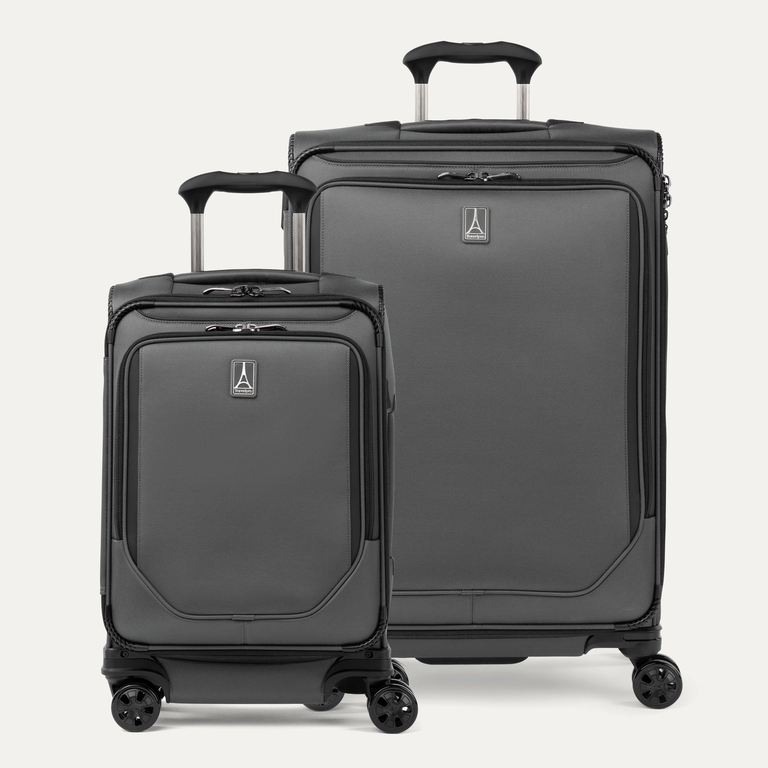 A set of two gray spinner suitcases, one carry-on size and one check-in size on a white background 
