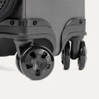Close-up of suitcase wheels on a white background