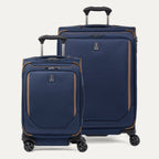 A set of two blue spinner suitcases, one carry-on size and one check-in size, with brown accents on a white background 