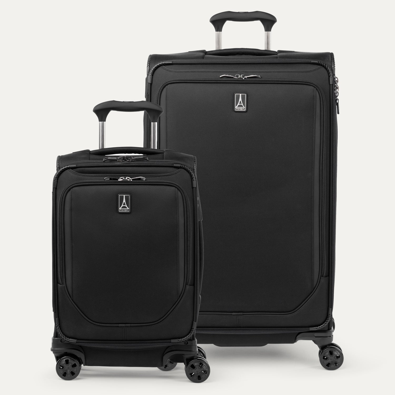 A set of two black spinner suitcases, one carry-on size and one check-in size on a white background 